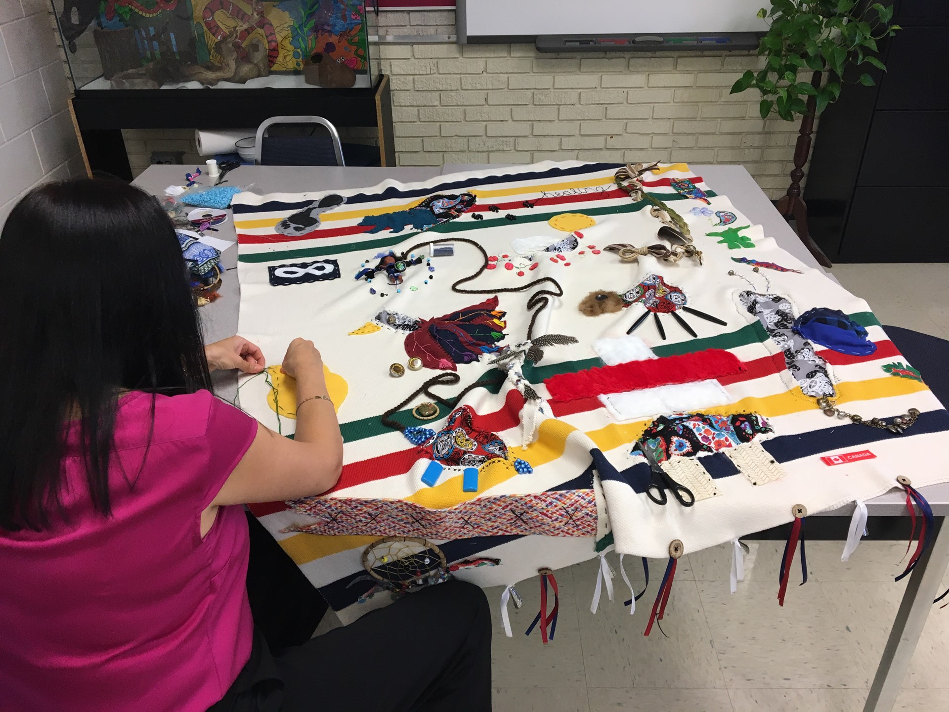 Student working on mending the blanket project.jpg